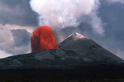 photo 032.  Photo of red-hot lava fountaining low and more gently from crater