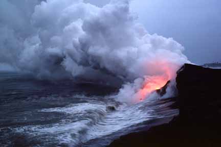 photo 044.  Photo taken at dusk of large steam cloud forming as glowing lava flows into sea