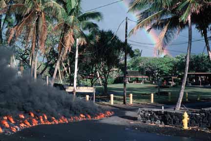 photo 065.  Photo of lava burning its way across pavement with park in background
