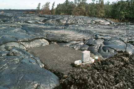 photo 074.  Photo of lava surrounding three sides of grave