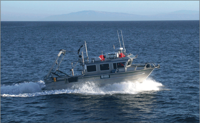 Small boat traveling through a large water body with various instruments attached.