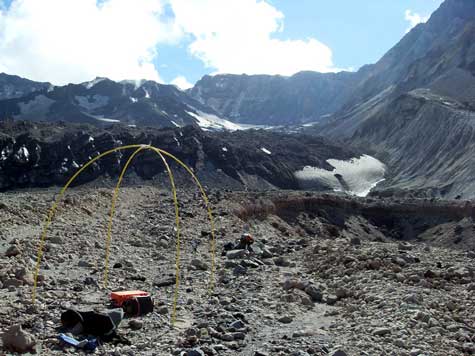 The controlled-source audio-frequency magnetotelluric (CSAMT) transmitter for repeat station MSH-1001-1002, located north of Crater Glacier (black ridge visible in the middle distance) and the 1980–86 and 2004–2008 dacite lava domes (left upper background) inside Mount St. Helens crater (crater walls seen in the top center and upper right).