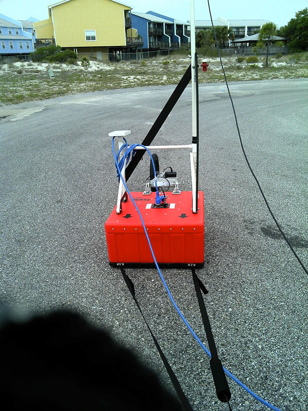 Photograph of Geophysical Survey Systems, Inc. (GSSI) ground penetrating radar system being towed behind a vehicle, during field activity 13BIM01.