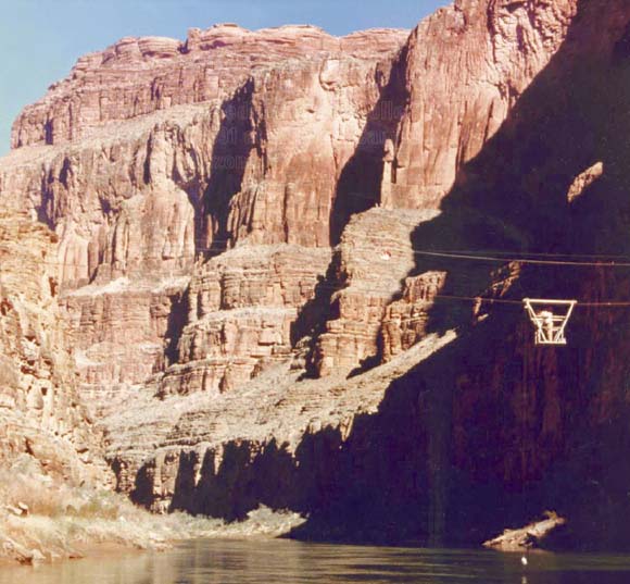 Photo of Colorado River with cliffs in the background and cable trolley in the foreground