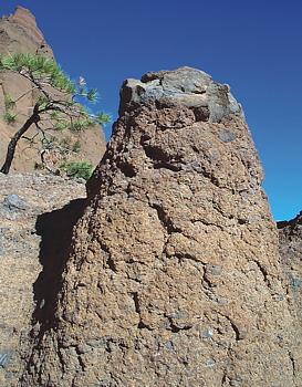 Close view of boulder capping hoodoo in amphitheater of Red Mountain