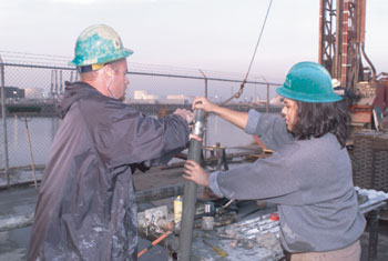 photo showing two scientists retrieving a core in the Los Angeles Basin
