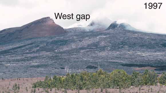 photograph of volcanic cone with large gap near top taken in 1997