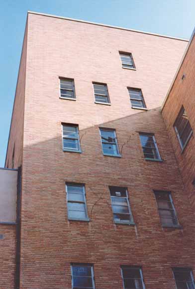 close-up photo of brick building showing cracks in the wall