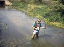 Figure 9 is a photograph showing a USGS employee using a measuring instrument.