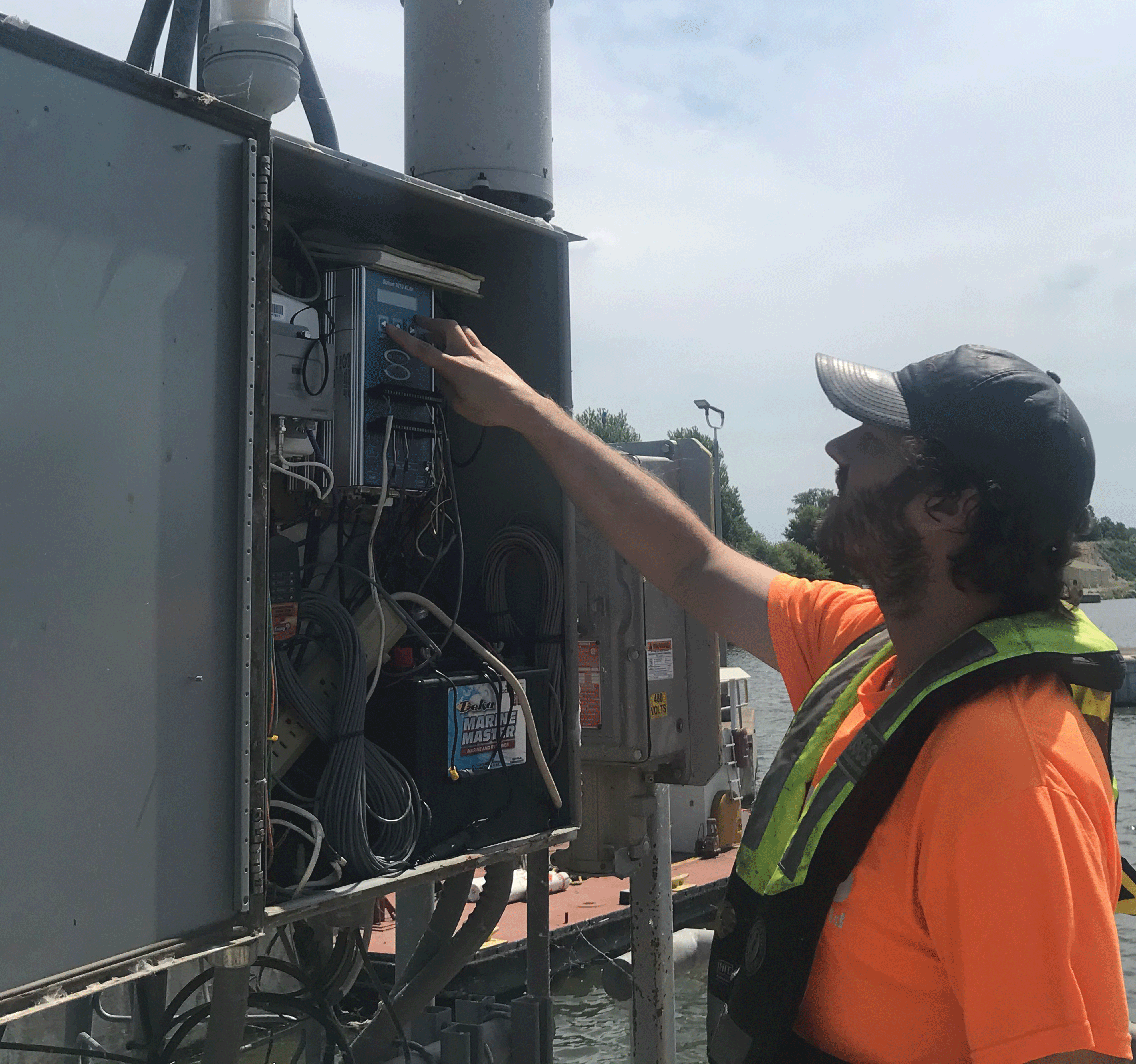 Man checks the equipment at a streamgage.