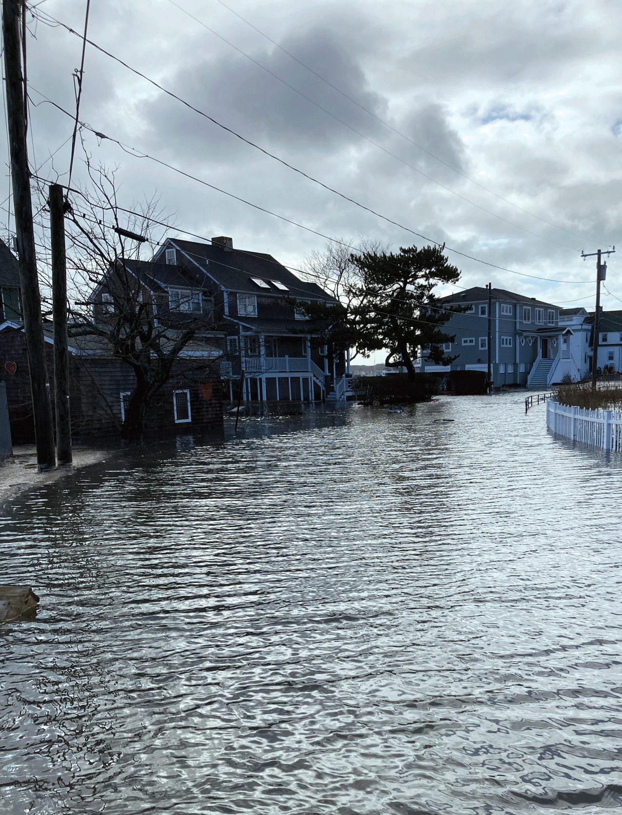 Photograph showing a flooded residential street in Niantic, Connecticut.