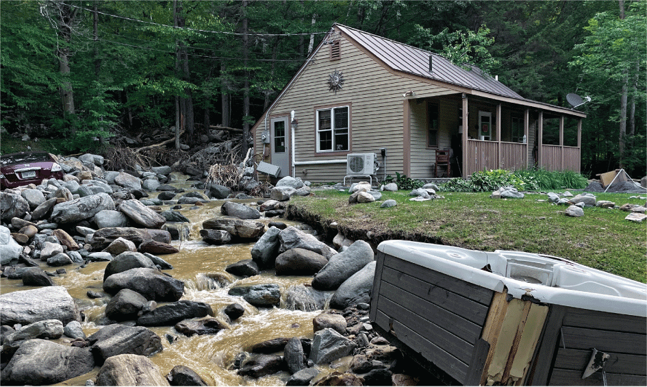 Boulders in front of a house. 