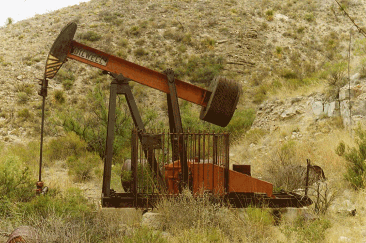 Photo of an abandoned pump jack well.