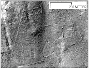 Aerial view identifies where stone walls, old buildings, and roads used to be.