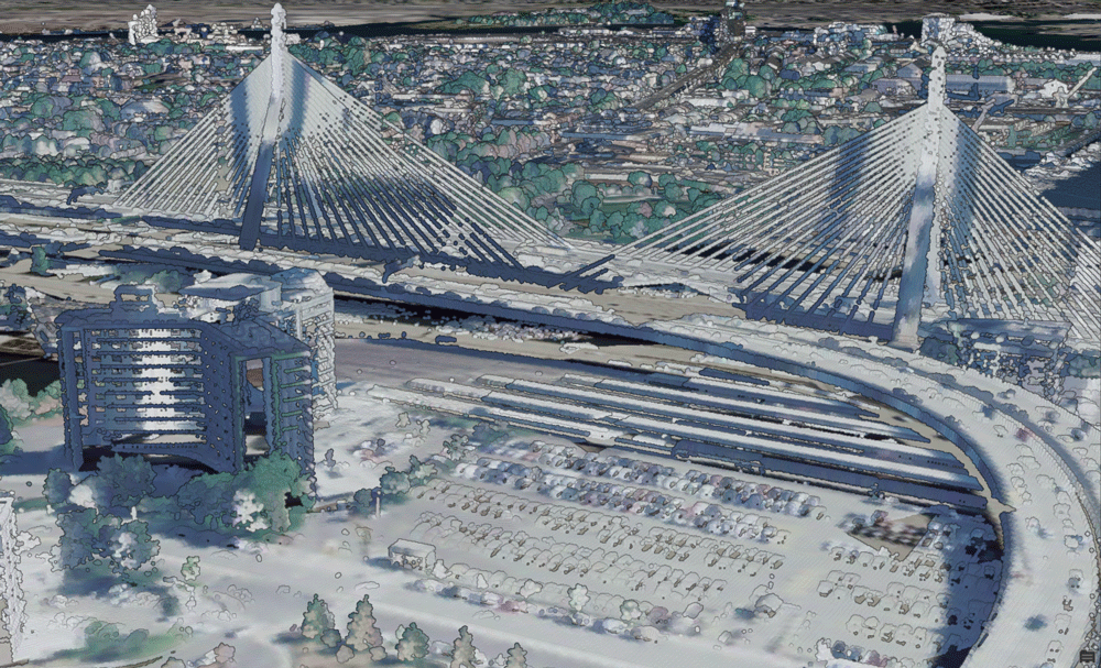 Aerial view of the bridge and an adjacent building and parking lot.