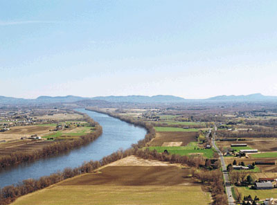 River running through farm land.