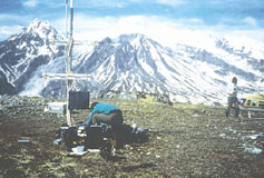 Picture of USGS volcano seismologists servicing a seismic station south of Crater Peak, Mt. Spurr volcano.