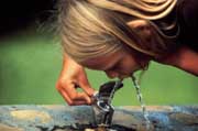 image of girl drinking from 
fountain
