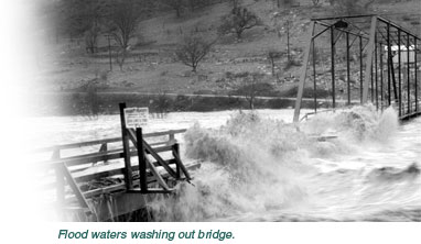 Flood waters washing out bridge