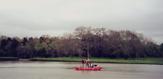 Photograph of USGS personnel collecting a sediment core on Clear Creek.