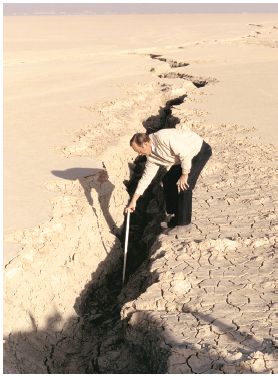 This earth fissure formed on Rogers Lake at Edwards Air Force Base, California, in January 1991, and forced the closure of one of the space shuttle’s alternative runways. The fissure has been attributed to land subsidence related to ground-water pumping in the Antelope Valley area (Galloway and others, 2003).