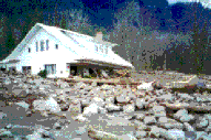 Debris flow in the Columbia River gorge surrounding a house.