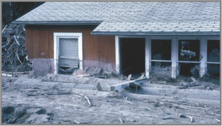 Red house partly buried by lahars