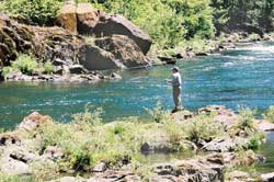 Figure 10 is a photograph showing a fisherman by a stream.