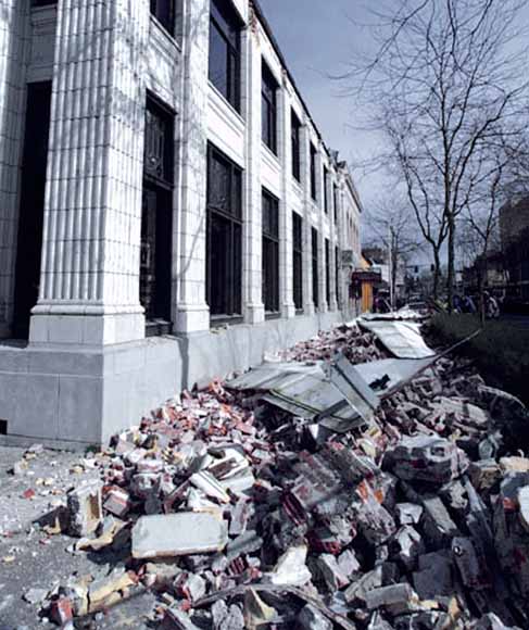 photo of bank building with heaps of rubble outside
