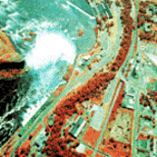 A fals color aerial photograph showing the water falls and building around it.
