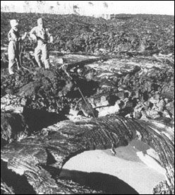 Scientist collecting sample from lava front