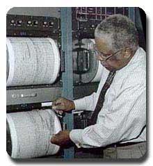 A color photograph of a man working in a magnetic tape library.  Photo: USGS