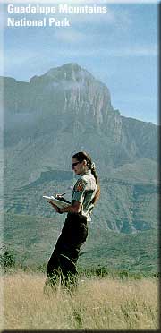A color photograph of a woman standing in front of Guadalupe Mountains National Park with a geologic map, photo: National Park Service