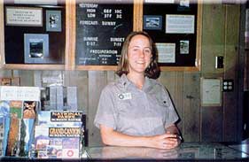 A color photograph of a young woman at the counter Sunset Crater Volcano National Monument, photo: National Park Service