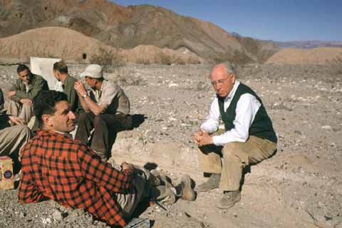 Photograph of six geologists gathered in the desert