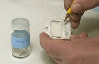 Label the sample holder with the pencil.