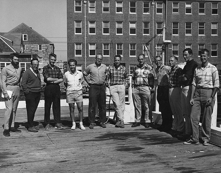 Personnel of the WHOI-USGS Atlantic Shelf and Slope Project assemble for their picture at the Institution on September 24, 1964.  From left: Dr. Frank T. Manheim, USGS; Dr. Elazar Uchupi, WHOI, Russel R. Paul, WHOI; Dr. Jobst Holsemann, WHOI; Dr. Robert H. Meade, USGS; Richard A. Tagg, USGS; Dr. K.O. Emery, WHOI; John C. Hathaway, USGS; Dr. Richard A. Pratt, WHOI; Joseph R. Frothingham, Jr., WHOI; and Dr. John S. Schlee, USGS.