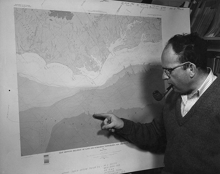 Dr. Elazar Uchupi, WHOI, locates the Hatteras Canyon on this new map showing the submarine topography of the Atlantic Continental Shelf and Slope.  The U.S. Geological Survey and Woods Hole Oceanographic Institution are preparing three such sheets that will map the shelf at a scale of 1 inch equals 16 miles from Nova Scotia to Florida - the first detailed series of its kind.