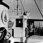 As the 99-foot Research Vessel GOSNOLD hovers near the edge of the Continental Shelf - 90 miles south of Nantucket - Seaman Earl "Skip" Moody prepares to identify a passing ship with binoculars.