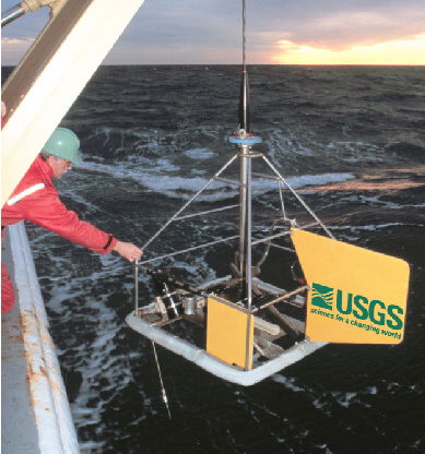 Figure 5. U.S. Geological Survey scientist recovering the sediment sampler that was in use at the time of cruise number SEAX96004.