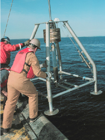 Figure 4. U.S. Geological Survey employees retrieving the hydrostatically damped gravity corer on the back of the ship after sampling the seabed.