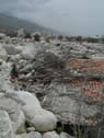 Roof of a one-story residence buried by debris flow