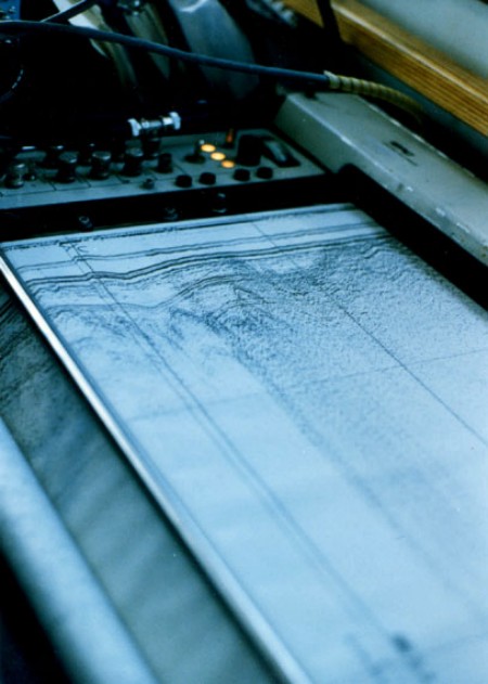 Seismic record being generated on an EPC graphic recorder , with time marks labeled, during a cruise aboard the RV ASTERIAS.  