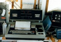 From left to right, aboard the RV ASTERIAS: reel-to-reel, 8-track tape recorder for recording seismic data; "Silent 700" recorder and hard-copy printer terminal for navigation data; USGS cruise operations manual (blue folder); Loran-C display box; and (lower right) manual trigger for marking records.  