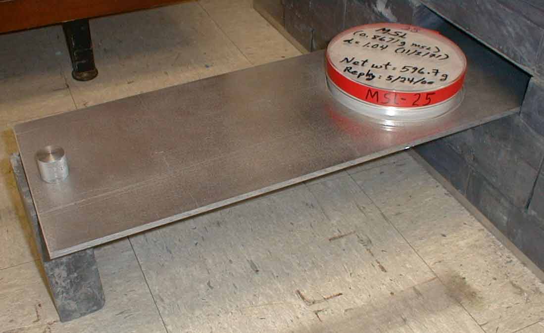 Photo of a sample container placed in the sample holder and pulled out of castle.