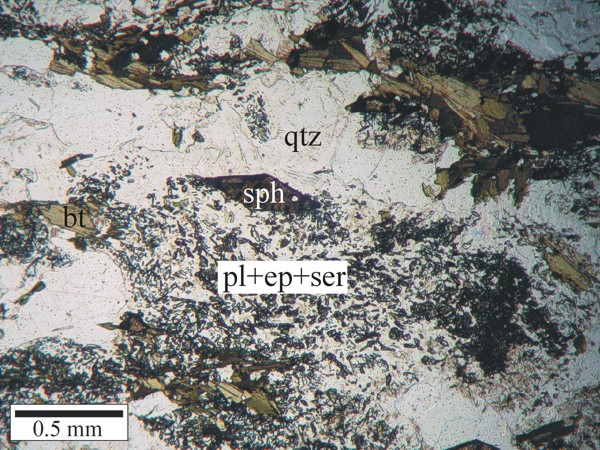Orthogneiss showing severe alteration of plagioclase to sericite and sausserite (fine grained epidote). Euhedral rhomboid-shaped sphene grain may be of a secondary growth.