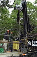 Photograph shows the sonic drill rig with the drill casing partially penetrated.