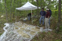 Photograph shows the tent used by the wellsite geologist and the core sample which have been extracted in plastic sleeves.