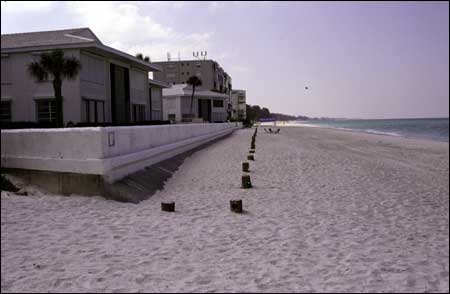 Seawall protecting homes from storm waves and beach erosion.