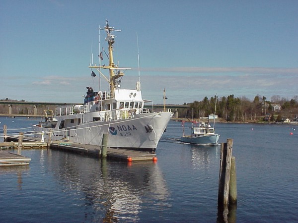 Starboard-side view of the NOAA Ship RUDE docked near a passing lobster boat.